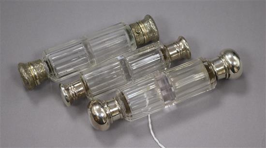 A late Victorian silver mounted glass double ended scent bottle and two other double ended scent bottles, largest 15cm.